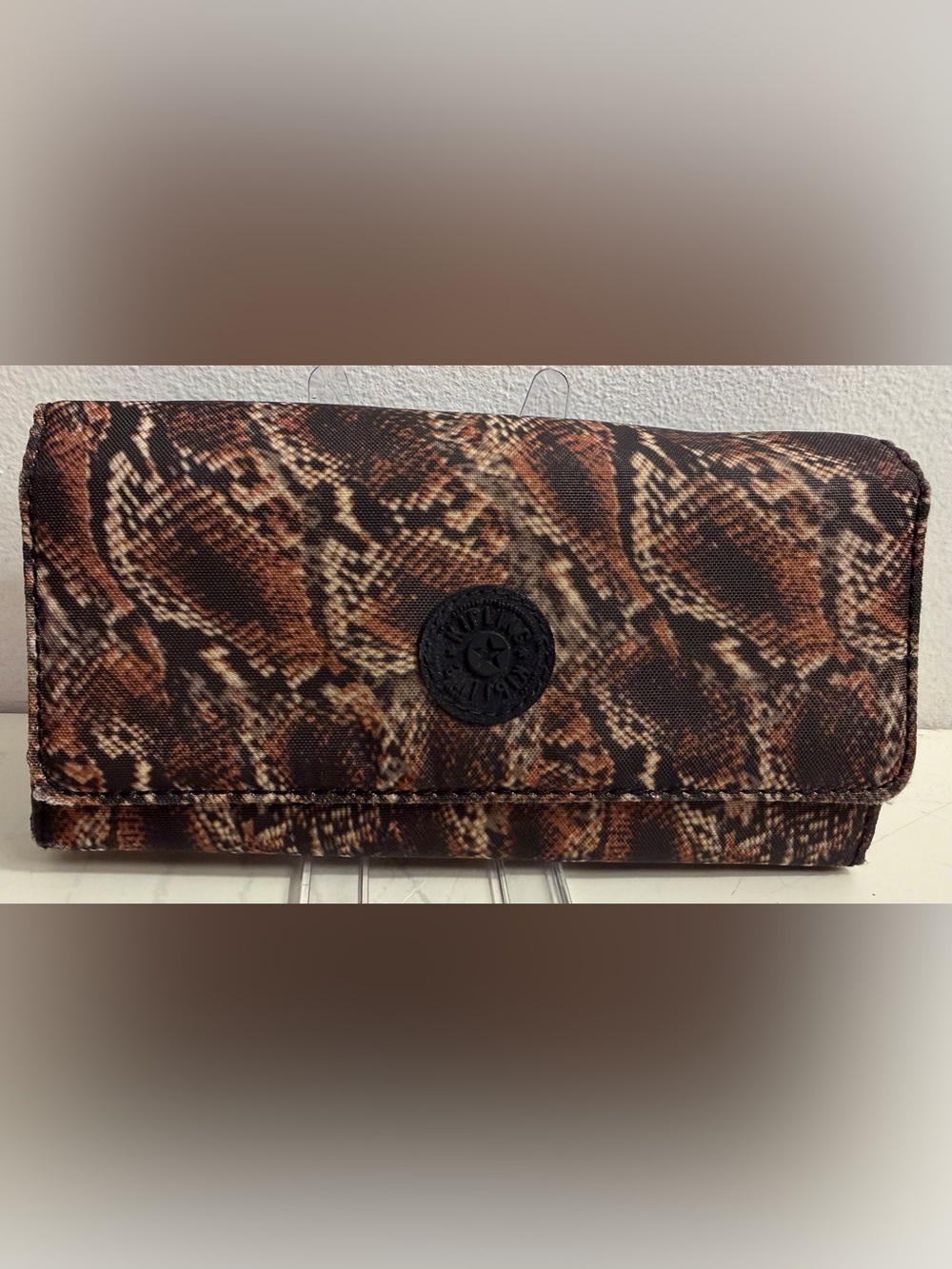 Kipling trifold wallet in snakeskin pattern.